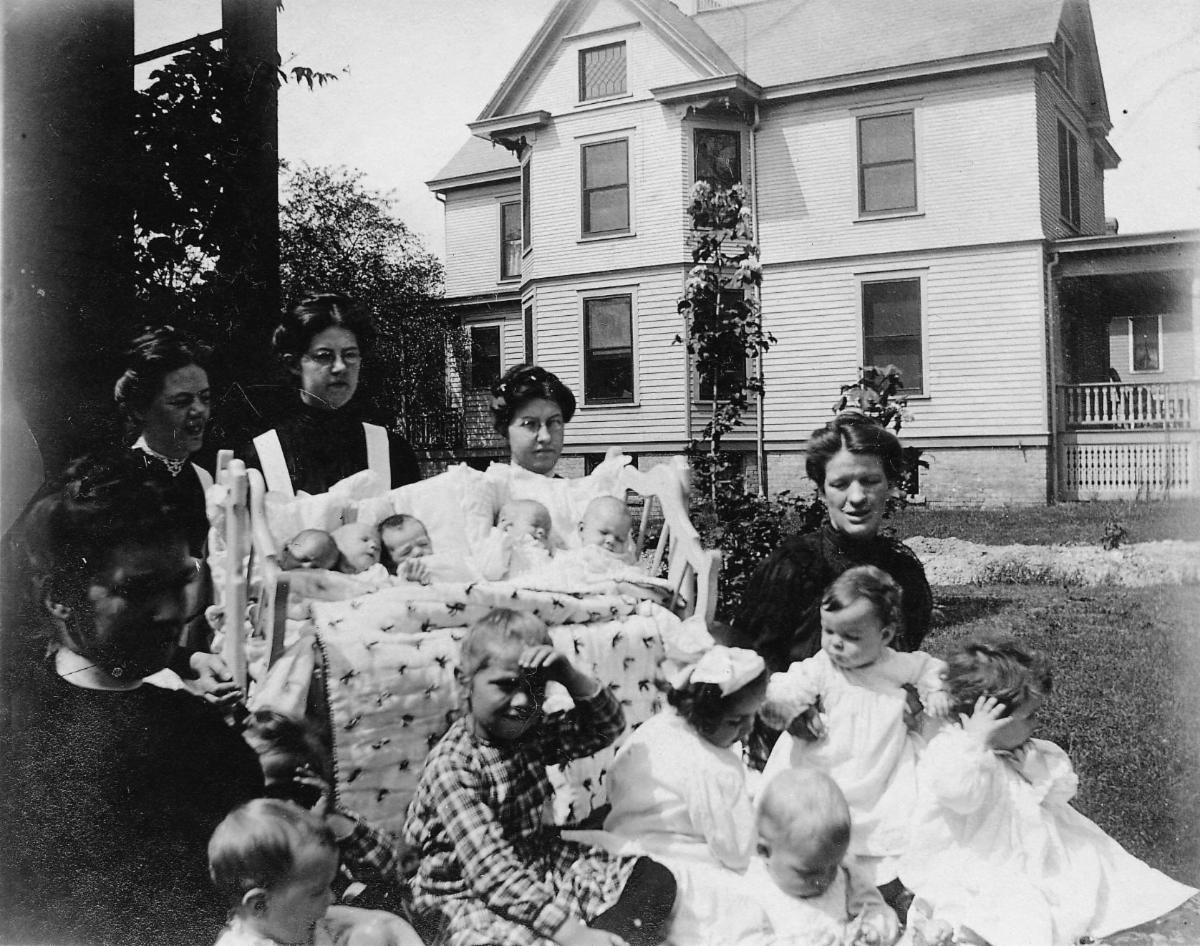 Deaconesses outside on lawn with children 1920